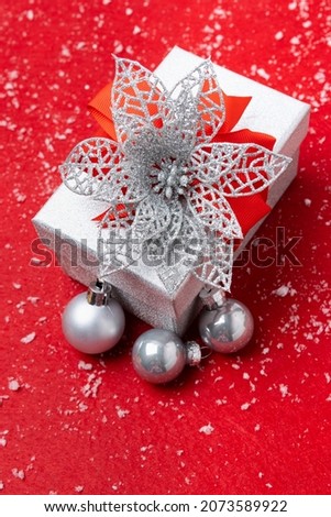 Christmas decoration on red background and snow