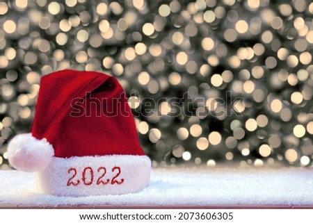 Happy new year 2022 Santa Hat and white snow.
