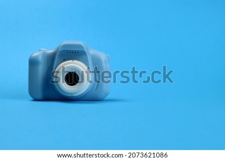 plastic toy camera for children on a blue background. Copy space for text