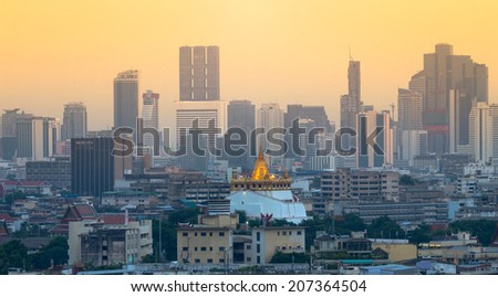 Golden mountain, an ancient pagoda at Wat Saket temple at evening time with cityscape background in Bangkok, Thailand