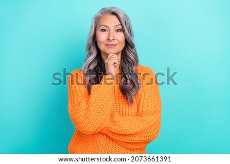 Portrait of attractive content grey-haired woman thinking making decision isolated over vivid teal turquoise color background