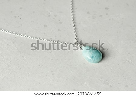 Aquamarine natural pendant, necklace. A short necklace made of Aquamarine. Handmade jewelry made from natural stones. Modern Author's jewelry. Natural blue Aquamarine pendant on silver chain. Royalty-Free Stock Photo #2073661655