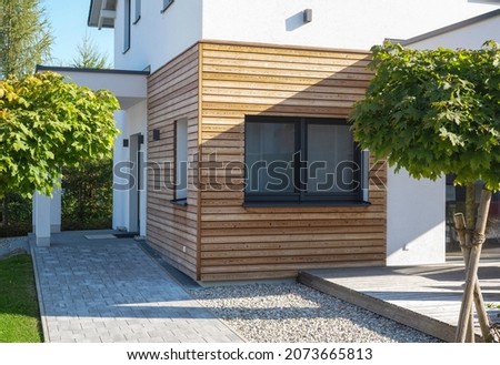 Finished house with fast construction, wooden cladding, economical environmentally friendly technology. Modern, elegant, minimalist style passive house with recycled materials. Tiny house with a youth Royalty-Free Stock Photo #2073665813