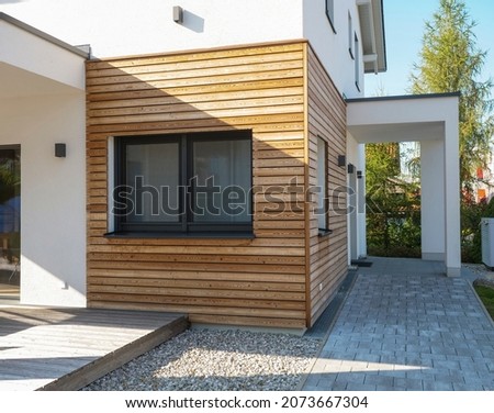 Finished house with fast construction, wooden cladding, economical environmentally friendly technology. Modern, elegant, minimalist style passive house with recycled materials. Tiny house with a youth Royalty-Free Stock Photo #2073667304