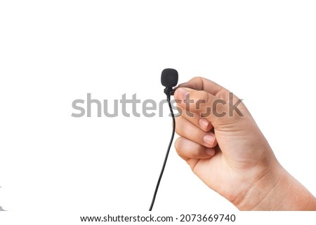 Lavalier microphone in hand on a white background.