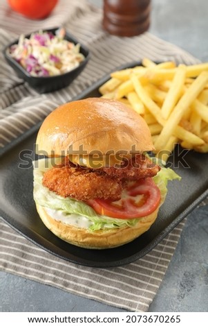 Fried chicken cheese sandwich with lettuce and tomato. This photo can be used in restaurants, menu, advertising, unhealthy and healthy food! Fast food and junk food, Oil ...
