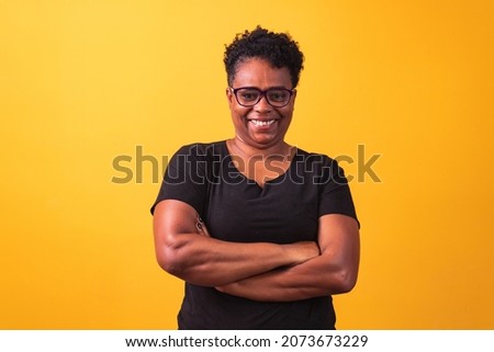 mature woman wearing prescription glasses. black woman with glasses with cross arms  Royalty-Free Stock Photo #2073673229
