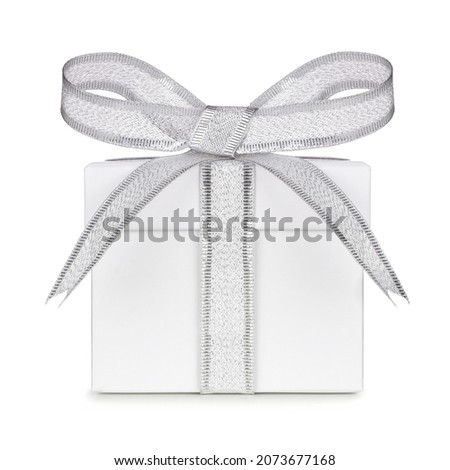 White gift box wrapped with shiny silver bow and ribbon isolated on a white background