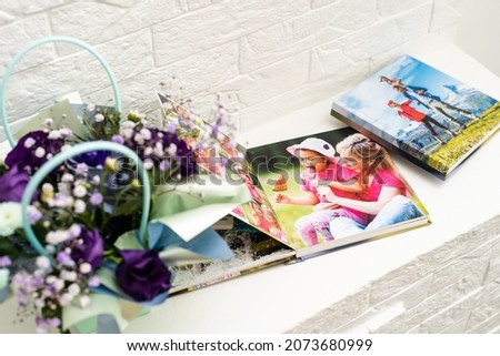album photo book with the inscription with a decor next to flowers, view from above