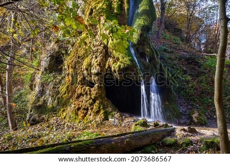 Beautiful rock waterfall in the autumn forest. Maliivtsi. 