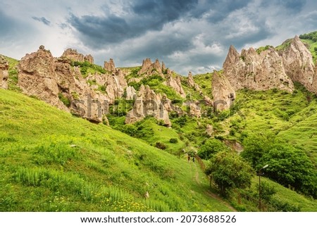 Ancient cave dwellings in a city carved out of soft sandy rocks are the main attraction of the city of Goris in Armenia. Royalty-Free Stock Photo #2073688526