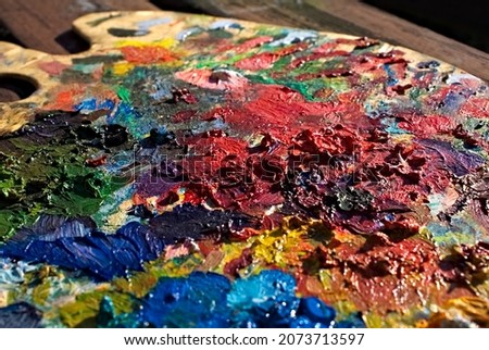 close-up of paints on a palette. Painting palette. oil paint. Colored stains from mixed paint.