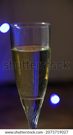 a glass of champagne on a blurred background