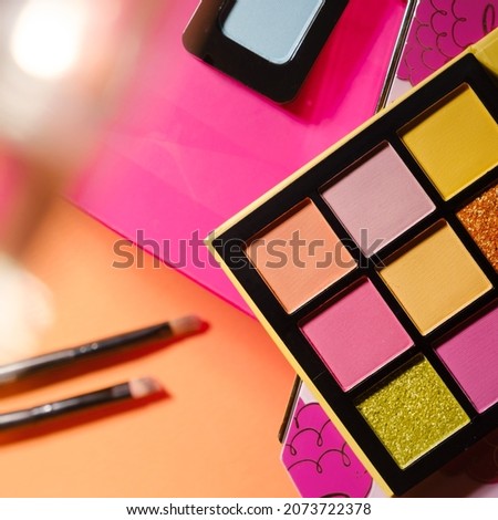 Eyeshadow Palette with nine bright, metallic, and matte shades at colorful background