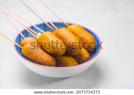 Corn dog cooked with sausage and wheat dough with the addition of corn flour, side view Royalty-Free Stock Photo #2073754373