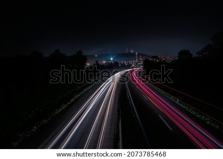 A beautiful horizontal background of a road light trail; long-exposure photography