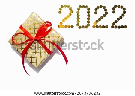 A New Year's gift on a white background and the numbers 2022.