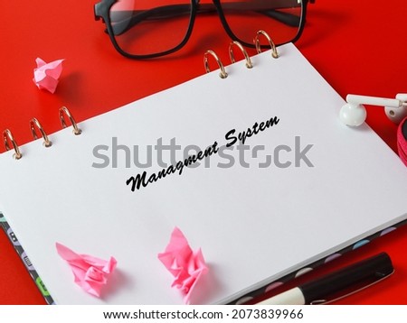 Images note book with management system on red background