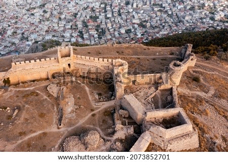 Aerial view of the ruins of the ancient Greek fortress Larisa with stone walls and towers over the modern Greek city of Argos in the background Royalty-Free Stock Photo #2073852701