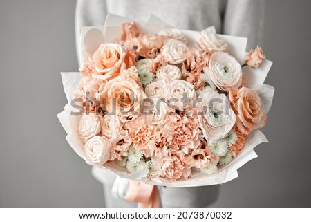 Beautiful bouquet of mixed flowers with ranunculus clooney hanoi in woman hand. Floral shop concept . Beautiful fresh cut bouquet. Flowers delivery Royalty-Free Stock Photo #2073870032