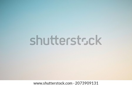 Summer holiday concept. Abstract blur blue, yellow, and orange color sky beach sunset background. sky at sunset blurry background. Light Blue background. Sky background. Royalty-Free Stock Photo #2073909131