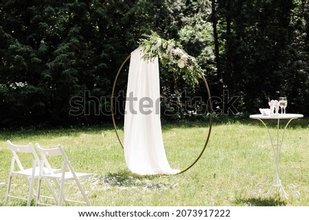 Round wedding arch on a background of trees. High quality photo