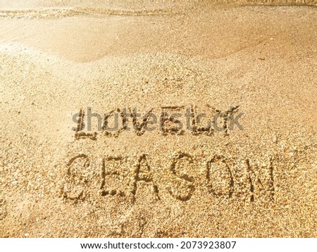 Lovely Season lettering on the sea sand - summer vacation at the sea