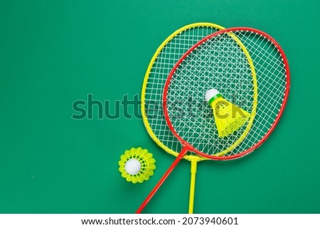 Two shuttlecock and badminton racket. on a green background. Concept summer relaxation.