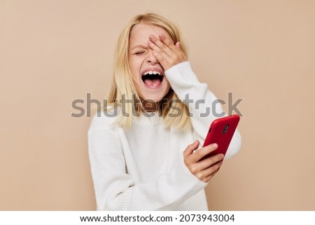 happy cute girl communication smartphone entertainment on a beige background
