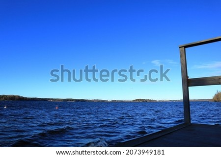 Great seaside an autumn day. Blue sky and water. At a wooden bridge or jetty. Stockholm, Sweden.