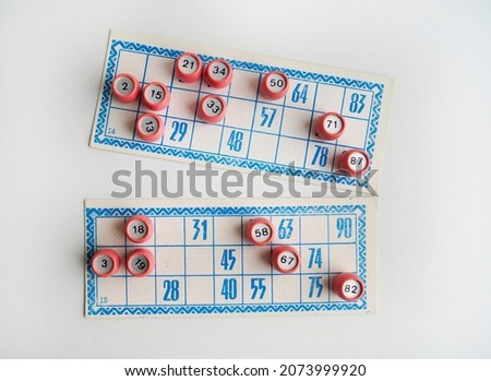 Lotto cards with numbers lie on a white background