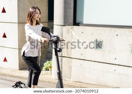 Person using an Electric Scooter Royalty-Free Stock Photo #2074010912