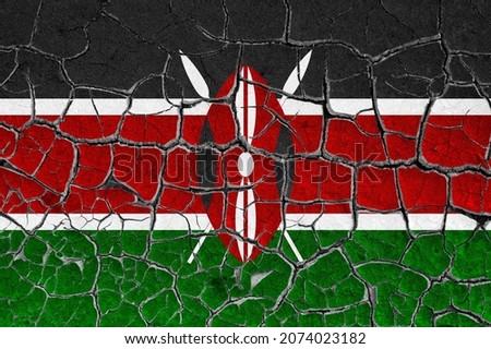 Flag of Kenya on a cracked wall, dry ground