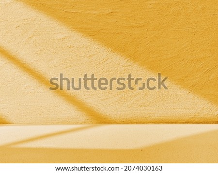 Yellow concrete background with light from the window
