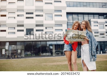 Elegant and stylish girls in a summer park