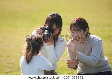 Mother taking pictures of children 

