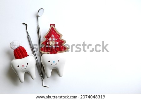 New Year. Christmas. dentist tools Dentistry.Dentist. Dentist. 2023 santa hat on tooth figurine