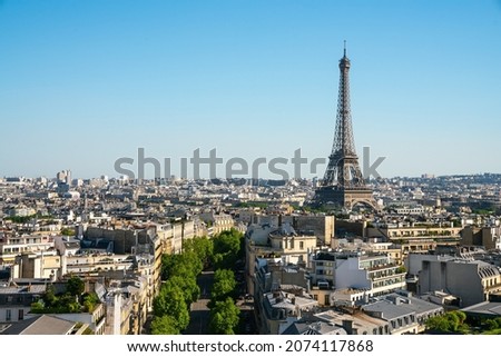 small paris street with view on the famous paris eiffel tower on a sunny day with some sunshine Royalty-Free Stock Photo #2074117868