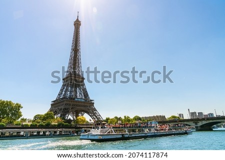 small paris street with view on the famous paris eiffel tower on a sunny day with some sunshine Royalty-Free Stock Photo #2074117874