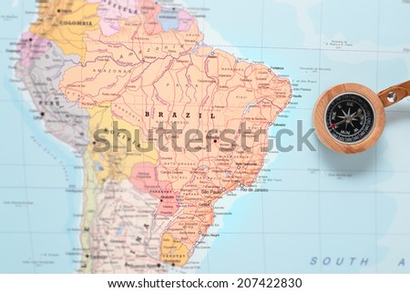 Compass on a map pointing at Brazil and planning a travel destination Royalty-Free Stock Photo #207422830
