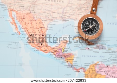 Compass on a map pointing at Mexico and planning a travel destination Royalty-Free Stock Photo #207422833