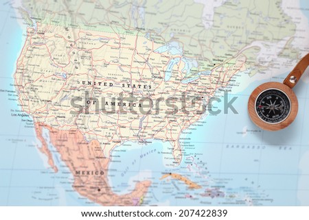 Compass on a map pointing at United States and planning a travel destination Royalty-Free Stock Photo #207422839