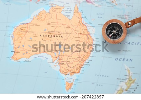 Compass on a map pointing at Australia and planning a travel destination Royalty-Free Stock Photo #207422857