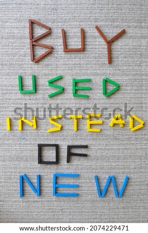 3D text in colored wooden bricks on wool carpet. It reads Buy Used Instead Of New. Message on sustainability, climate change, climate action, carbon footprint, CO2 emissions, sustainable development. Royalty-Free Stock Photo #2074229471