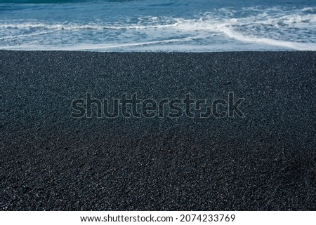  picture of the vulcanic black sand on the beach