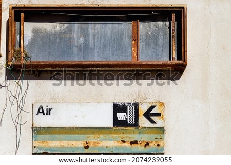 Air pump sign at abandoned gas station