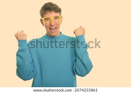 Studio shot of skinny man wearing sweater isolated against white background