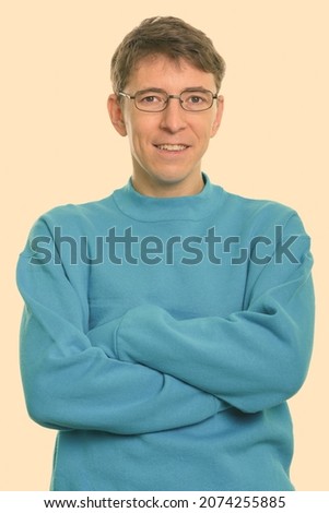 Studio shot of skinny man wearing sweater isolated against white background