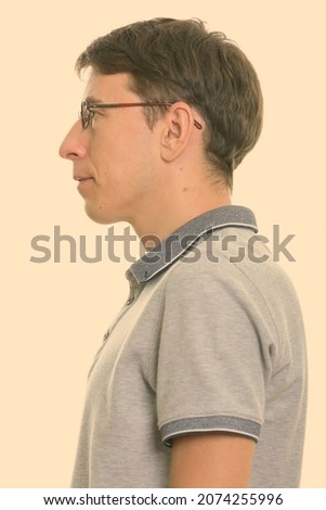 Studio shot of skinny man with short hair isolated against white background