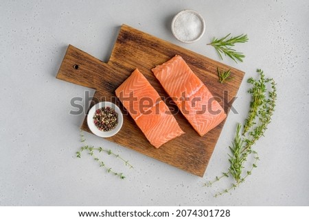 Fresh raw scandinavian salmon fillet. Rosemary and thyme. Salt and pepper. On old wooden board. Pescetarian seafood for cooking. Preparation nutrition seafish. Horizontal, top view Royalty-Free Stock Photo #2074301728